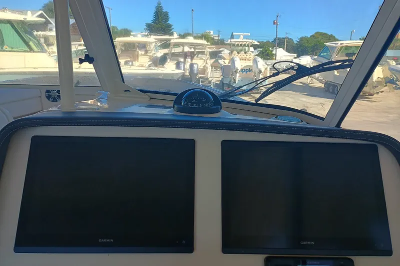325-708 Brokerage Josh Yacht Photos Pics 2021 Grady-White Freedom 325 boat dashboard with Garmin displays and compass.