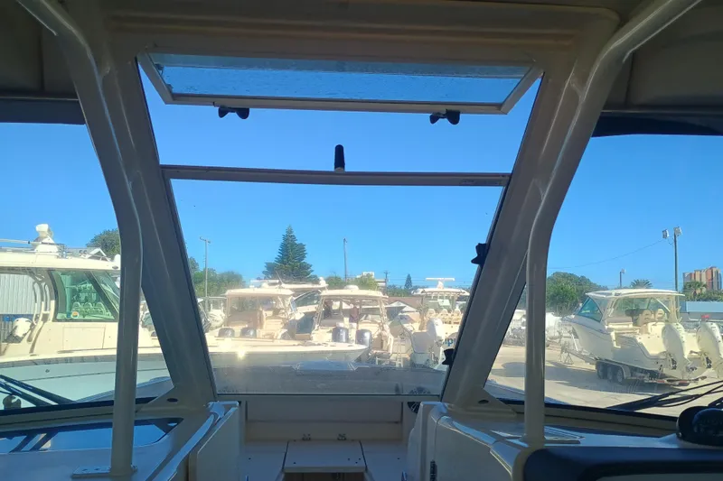 325-708 Brokerage Josh Yacht Photos Pics Interior view from a 2021 Grady-White Freedom 325 boat, overlooking a marina.