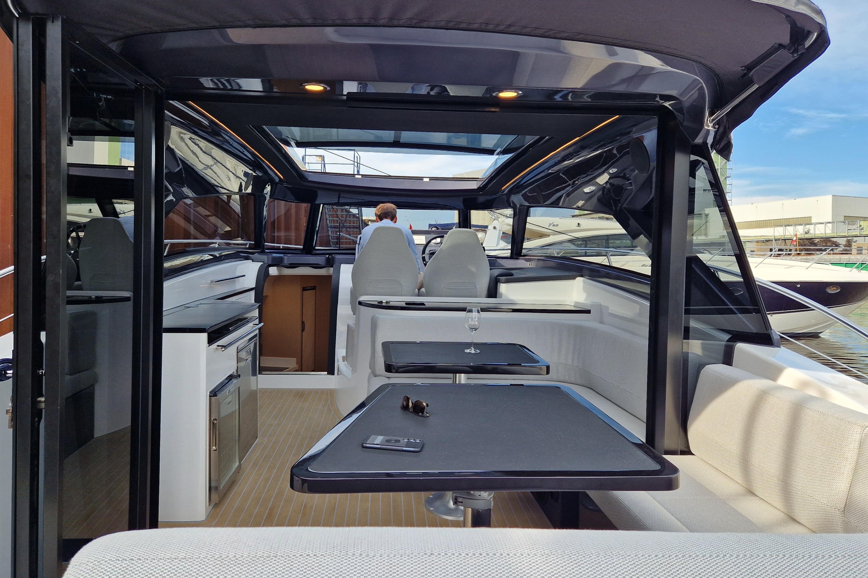 Luxurious interior of 2023 Focus Power 44 yacht with modern seating and table setup.