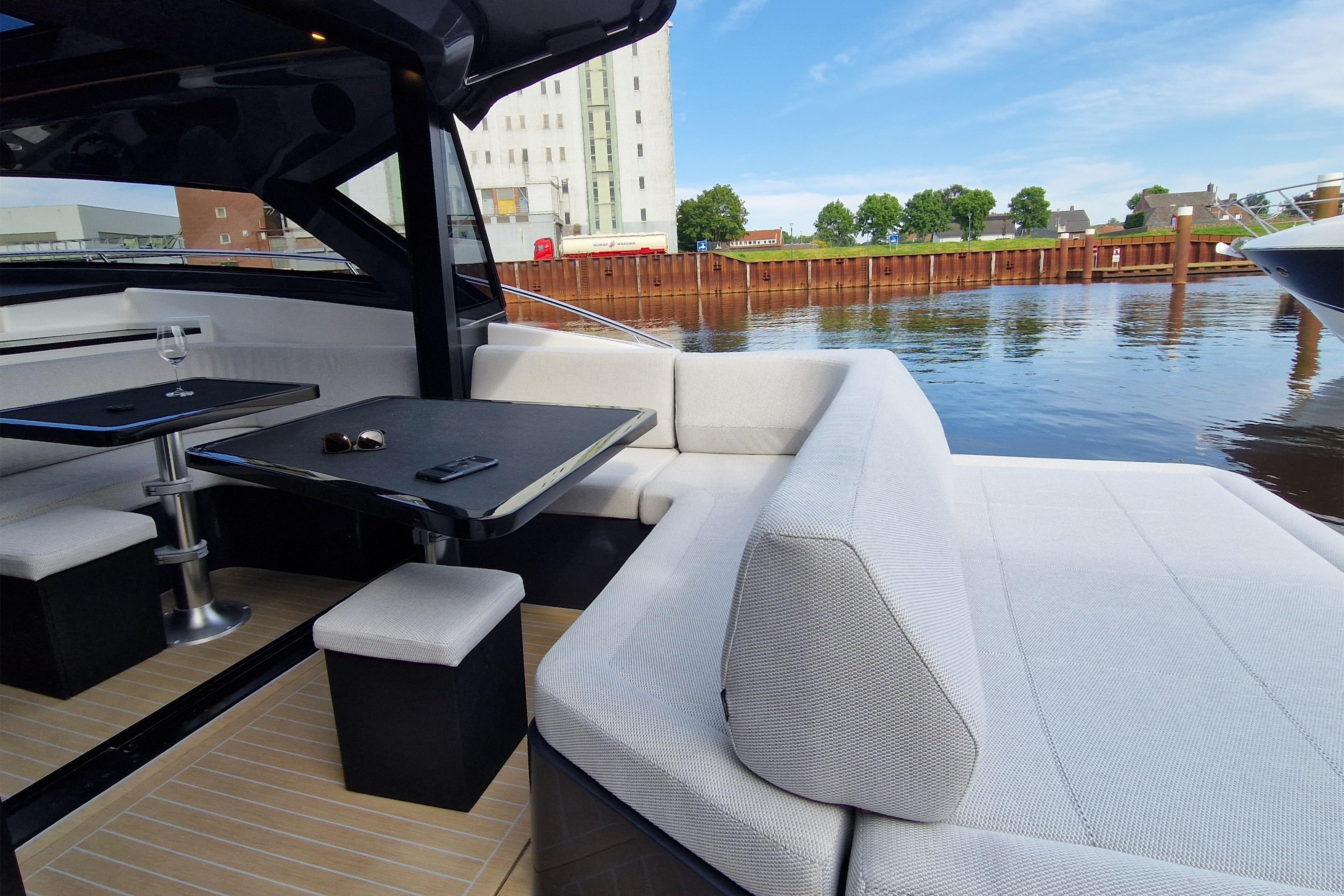 Luxurious 2023 Focus Power 44 yacht interior with elegant seating and waterfront view.