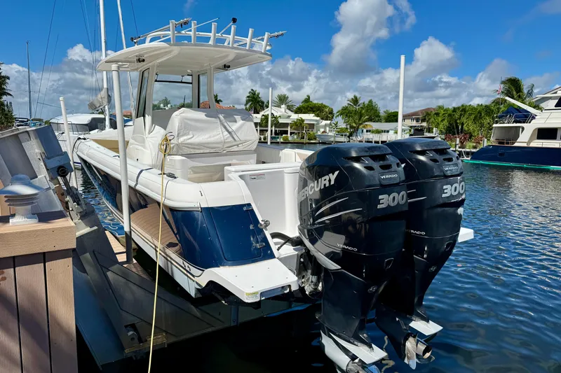  Yacht Photos Pics 2014 Intrepid 327 Center Console boat with twin Mercury 300 engines docked in marina.