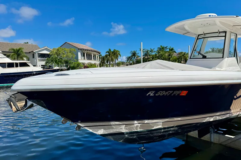  Yacht Photos Pics 2014 Intrepid 327 Center Console boat docked in sunny waterfront setting.