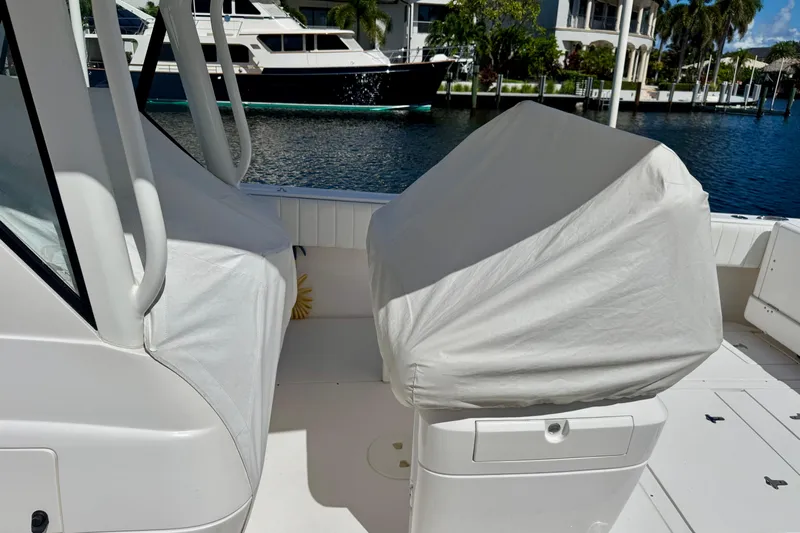  Yacht Photos Pics 2014 Intrepid 327 Center Console boat interior with covered seats, docked near luxury yachts.