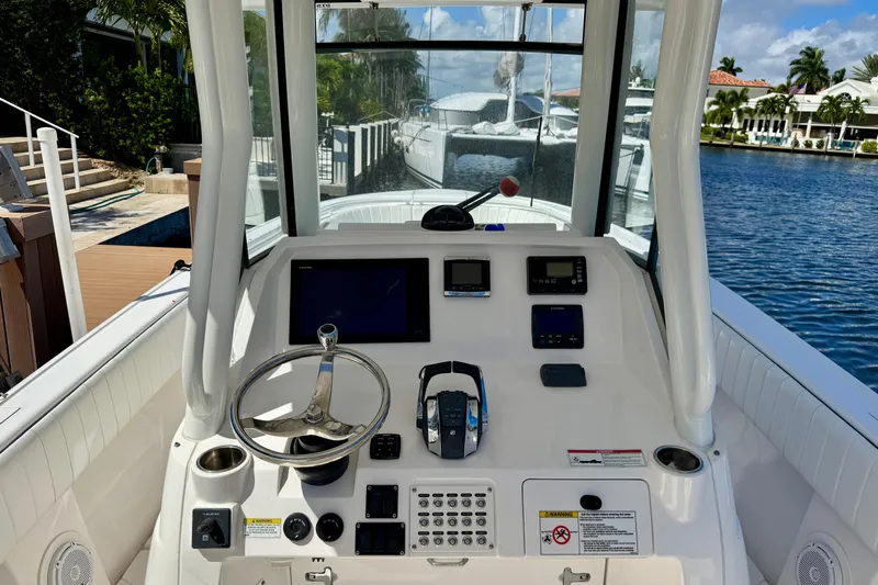  Yacht Photos Pics 2014 Intrepid 327 Center Console boat dashboard with steering wheel and navigation equipment.