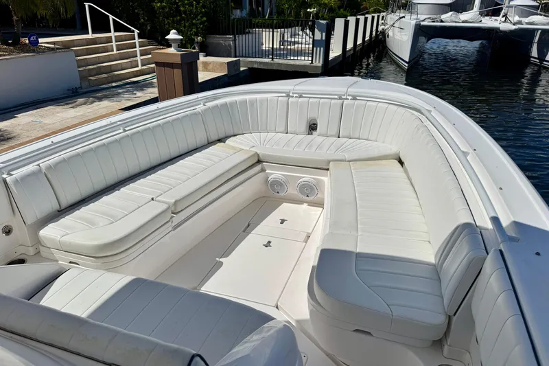  Yacht Photos Pics 2014 Intrepid 327 Center Console boat with spacious white seating area at dock.
