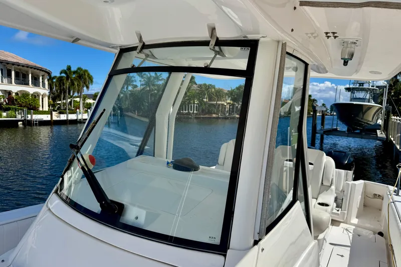  Yacht Photos Pics 2014 Intrepid 327 Center Console boat docked by waterfront homes.