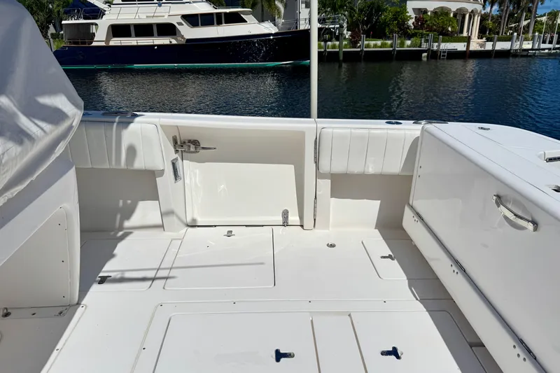  Yacht Photos Pics 2014 Intrepid 327 Center Console boat interior with docked yacht in background.