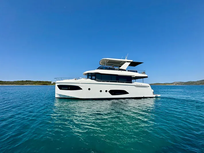  Yacht Photos Pics 2024 Absolute NAVETTA 52 yacht on clear blue water under a sunny sky.