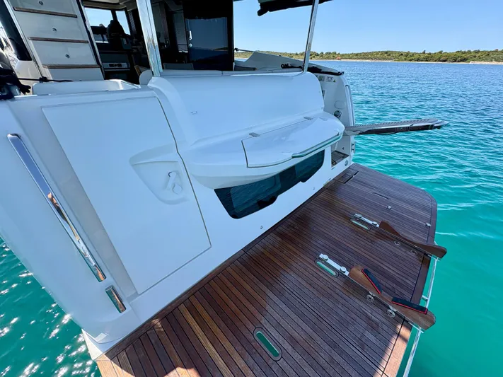  Yacht Photos Pics 2024 Absolute NAVETTA 52 yacht with open deck and swim platform on clear blue water.