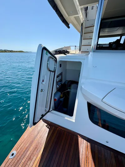  Yacht Photos Pics 2024 Absolute NAVETTA 52 yacht with open hatch, docked on calm water.