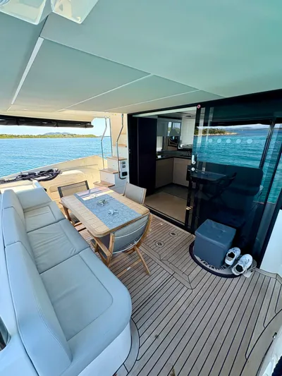  Yacht Photos Pics Luxurious 2024 Absolute NAVETTA 52 yacht deck with seating and ocean view.