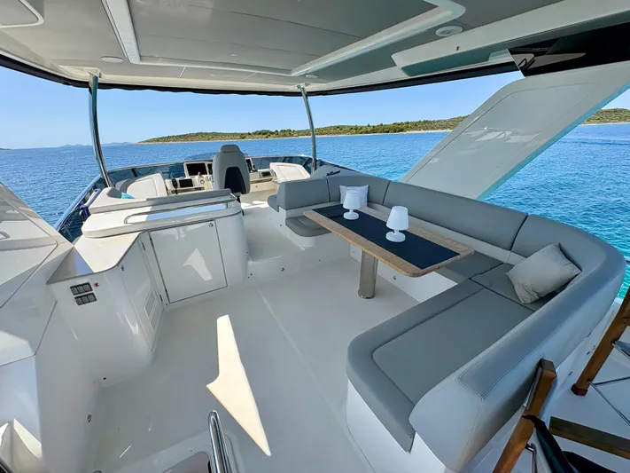  Yacht Photos Pics Luxurious 2024 Absolute NAVETTA 52 yacht interior with elegant seating and ocean view.