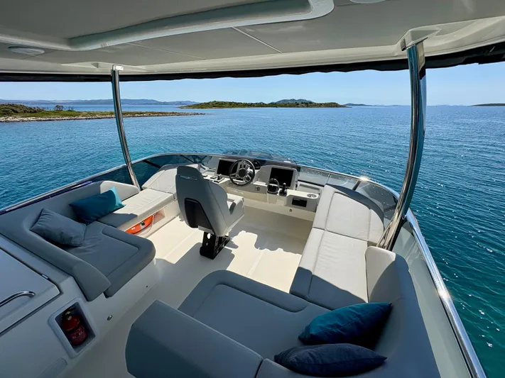  Yacht Photos Pics Luxurious 2024 Absolute NAVETTA 52 yacht interior with ocean view and modern seating.