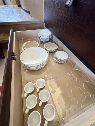  Yacht Photos Pics Drawer with neatly organized white dishes and cups in Absolute NAVETTA 52 yacht, 2024 model.
