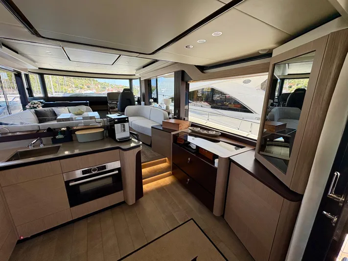  Yacht Photos Pics Luxurious interior of 2024 Absolute NAVETTA 52 yacht with modern kitchen and seating area.