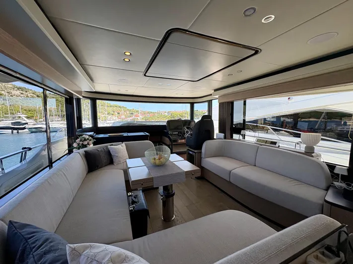  Yacht Photos Pics Luxurious interior of 2024 Absolute NAVETTA 52 yacht with elegant seating and panoramic windows.