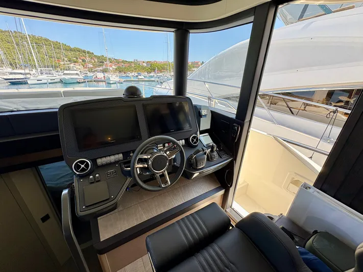  Yacht Photos Pics 2024 Absolute NAVETTA 52 yacht helm with modern controls and marina view.