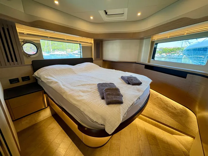  Yacht Photos Pics Luxurious bedroom interior of 2024 Absolute NAVETTA 52 yacht with modern design and large windows.