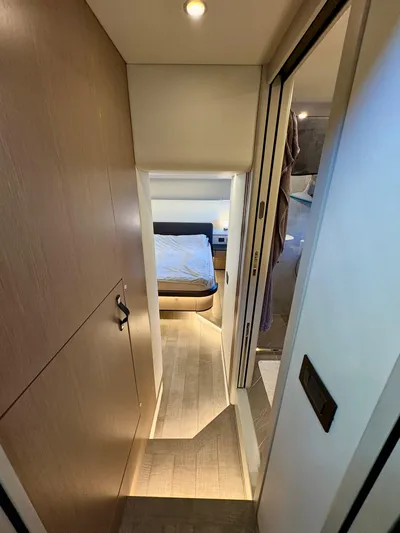  Yacht Photos Pics Interior hallway of 2024 Absolute NAVETTA 52 yacht, leading to a cozy bedroom.