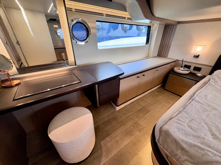  Yacht Photos Pics Luxurious interior of 2024 Absolute NAVETTA 52 yacht with elegant furnishings and porthole window.