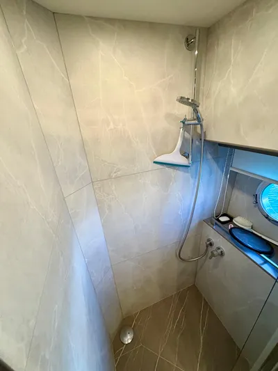  Yacht Photos Pics Luxurious shower area in 2024 Absolute NAVETTA 52 yacht, featuring elegant marble walls and modern fixtures.