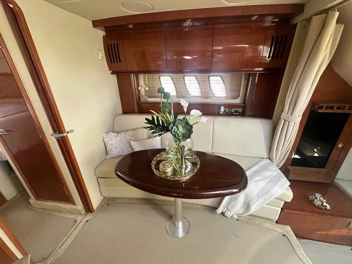 Salty Dawg Yacht Photos Pics Interior of 2006 Sea Ray 380 Sundancer with elegant seating and wooden table.