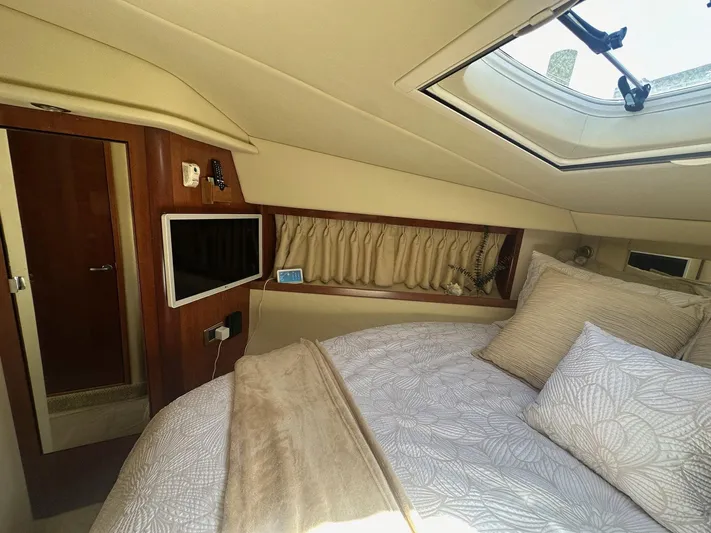 Salty Dawg Yacht Photos Pics Cozy cabin interior of 2006 Sea Ray 380 Sundancer with skylight and bedding.