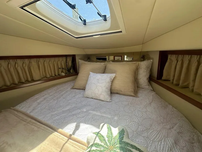 Salty Dawg Yacht Photos Pics Luxurious cabin interior of 2006 Sea Ray 380 Sundancer with skylight and plush bedding.