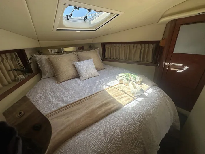 Salty Dawg Yacht Photos Pics Cozy cabin interior of 2006 Sea Ray 380 Sundancer with skylight and plush bedding.