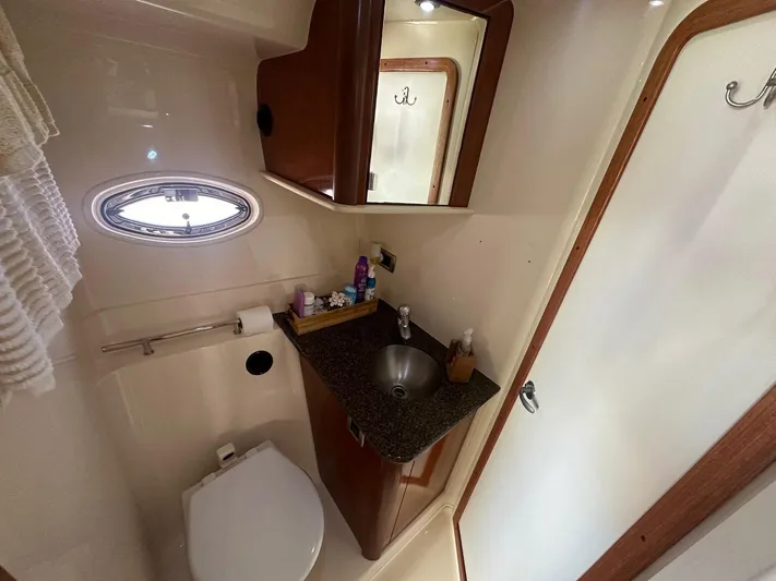 Salty Dawg Yacht Photos Pics Bathroom interior of 2006 Sea Ray 380 Sundancer yacht with sink and toilet.