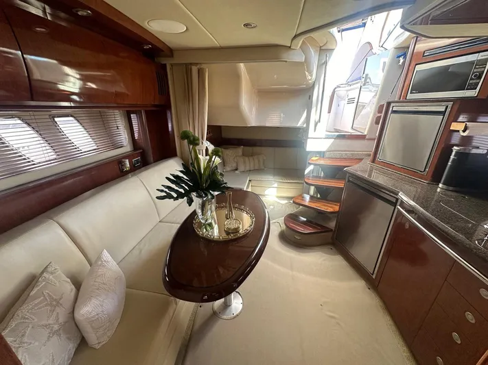 Salty Dawg Yacht Photos Pics Luxurious interior of 2006 Sea Ray 380 Sundancer yacht with elegant seating and modern kitchen amenities.
