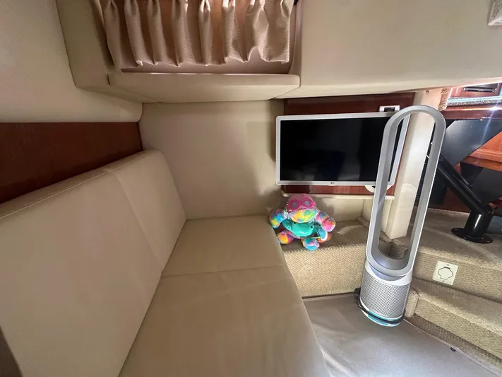 Salty Dawg Yacht Photos Pics Interior of 2006 Sea Ray 380 Sundancer with sofa, TV, and air purifier.