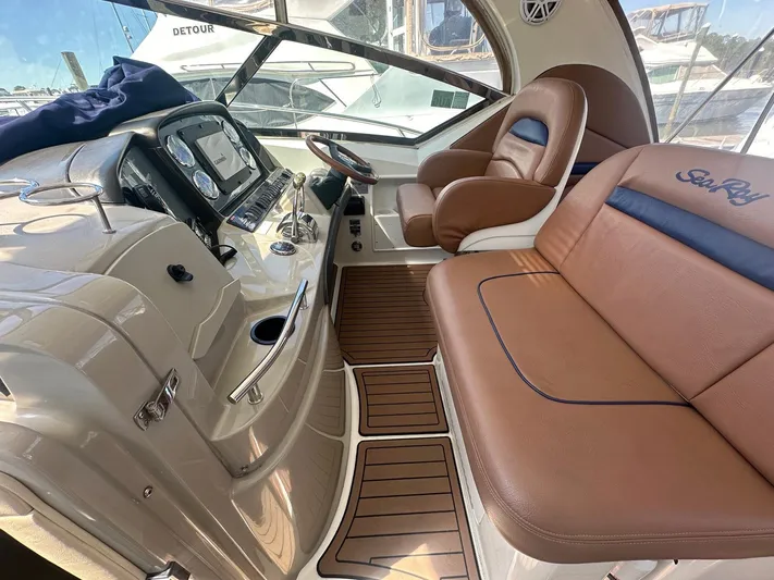 Salty Dawg Yacht Photos Pics 2006 Sea Ray 380 Sundancer cockpit with leather seating and modern dashboard.