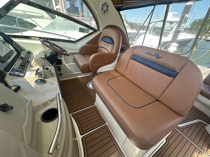 Salty Dawg Yacht Photos Pics 2006 Sea Ray 380 Sundancer helm with brown leather seating and wood accents.