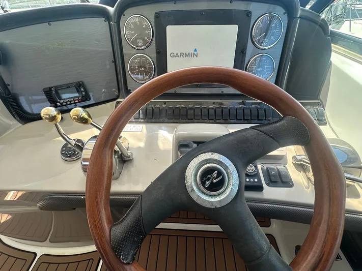 Salty Dawg Yacht Photos Pics 2006 Sea Ray 380 Sundancer helm with Garmin display and wooden steering wheel.