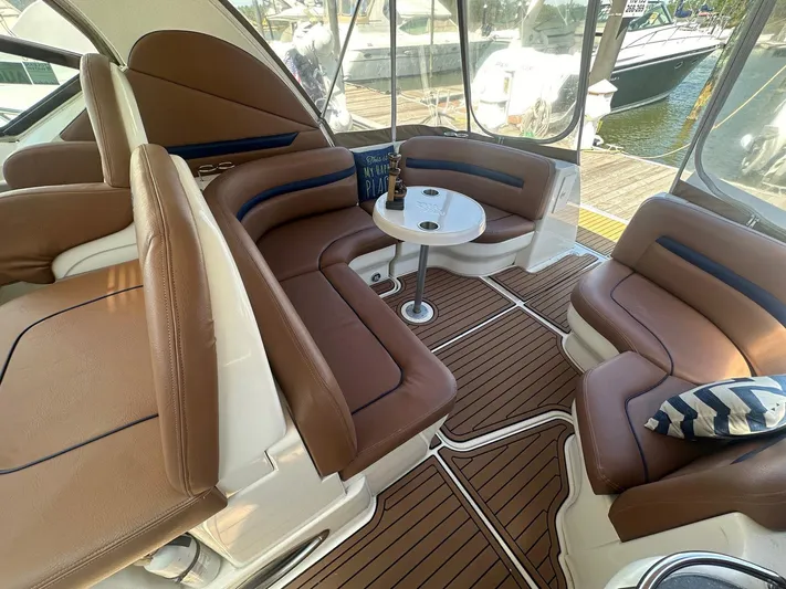 Salty Dawg Yacht Photos Pics 2006 Sea Ray 380 Sundancer interior with brown leather seating and a small table.