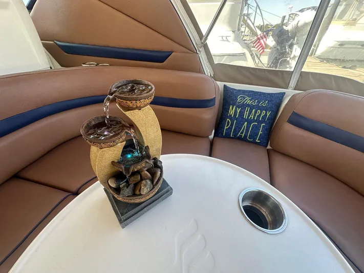 Salty Dawg Yacht Photos Pics 2006 Sea Ray 380 Sundancer interior with decorative fountain and "This is my happy place" pillow.