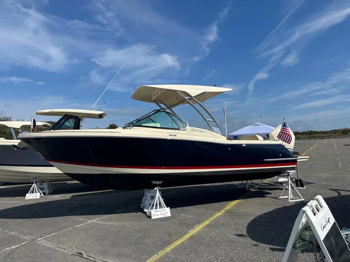  Yacht Photos Pics 2022 Chris-Craft Calypso 24 boat on display under a clear blue sky.