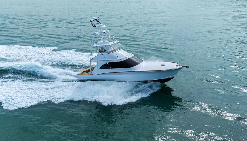  Yacht Photos Pics 2022 Jarrett Bay Flybridge Express cruising on open water, showcasing sleek design and performance.