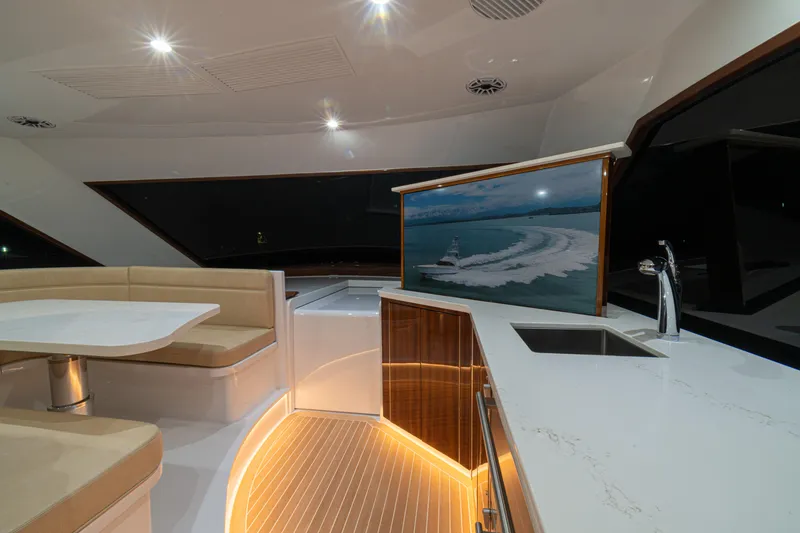 Yacht Photos Pics Luxurious interior of 2022 Jarrett Bay Flybridge Express yacht with modern seating and lighting.