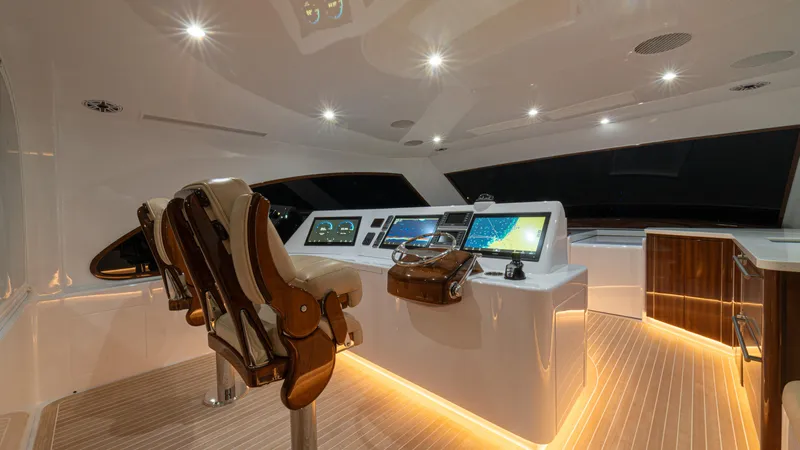  Yacht Photos Pics Luxurious 2022 Jarrett Bay Flybridge Express helm with modern controls and ambient lighting.