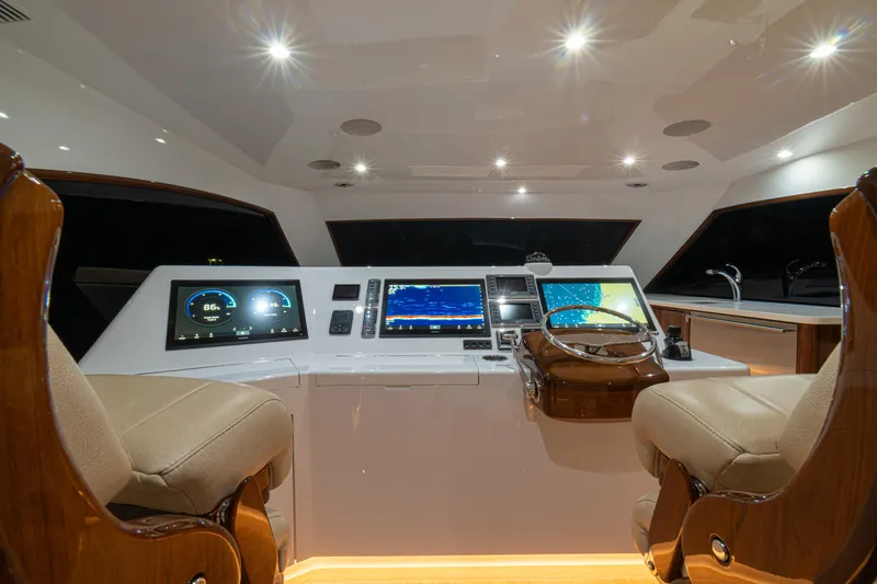  Yacht Photos Pics 2022 Jarrett Bay Flybridge Express helm with modern navigation displays and luxurious seating.