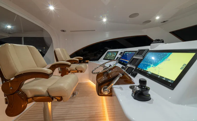  Yacht Photos Pics 2022 Jarrett Bay Flybridge Express helm with modern navigation displays and luxurious seating.