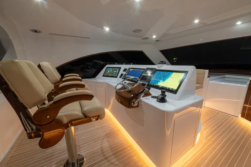  Yacht Photos Pics Luxurious 2022 Jarrett Bay Flybridge Express helm with modern navigation systems and plush seating.