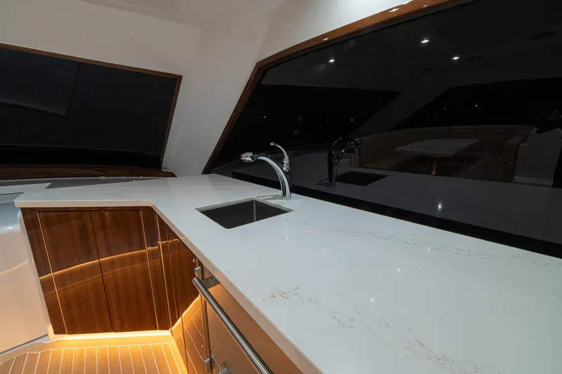  Yacht Photos Pics Luxurious 2022 Jarrett Bay Flybridge Express yacht interior with sleek countertops and modern fixtures.