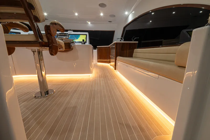  Yacht Photos Pics Luxurious 2022 Jarrett Bay Flybridge Express interior with ambient lighting and elegant seating.