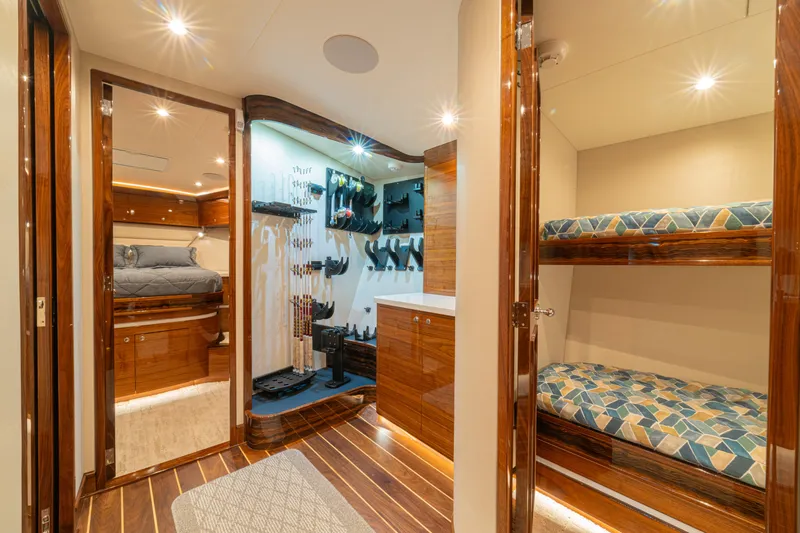  Yacht Photos Pics Luxurious 2022 Jarrett Bay Flybridge Express interior with wood finishes and bunk beds.