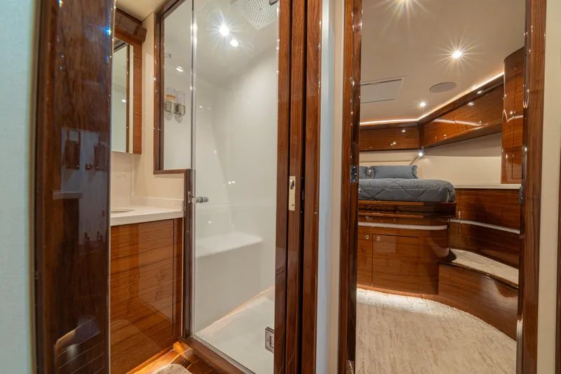  Yacht Photos Pics Luxurious 2022 Jarrett Bay Flybridge Express interior with wood finishes and modern amenities.