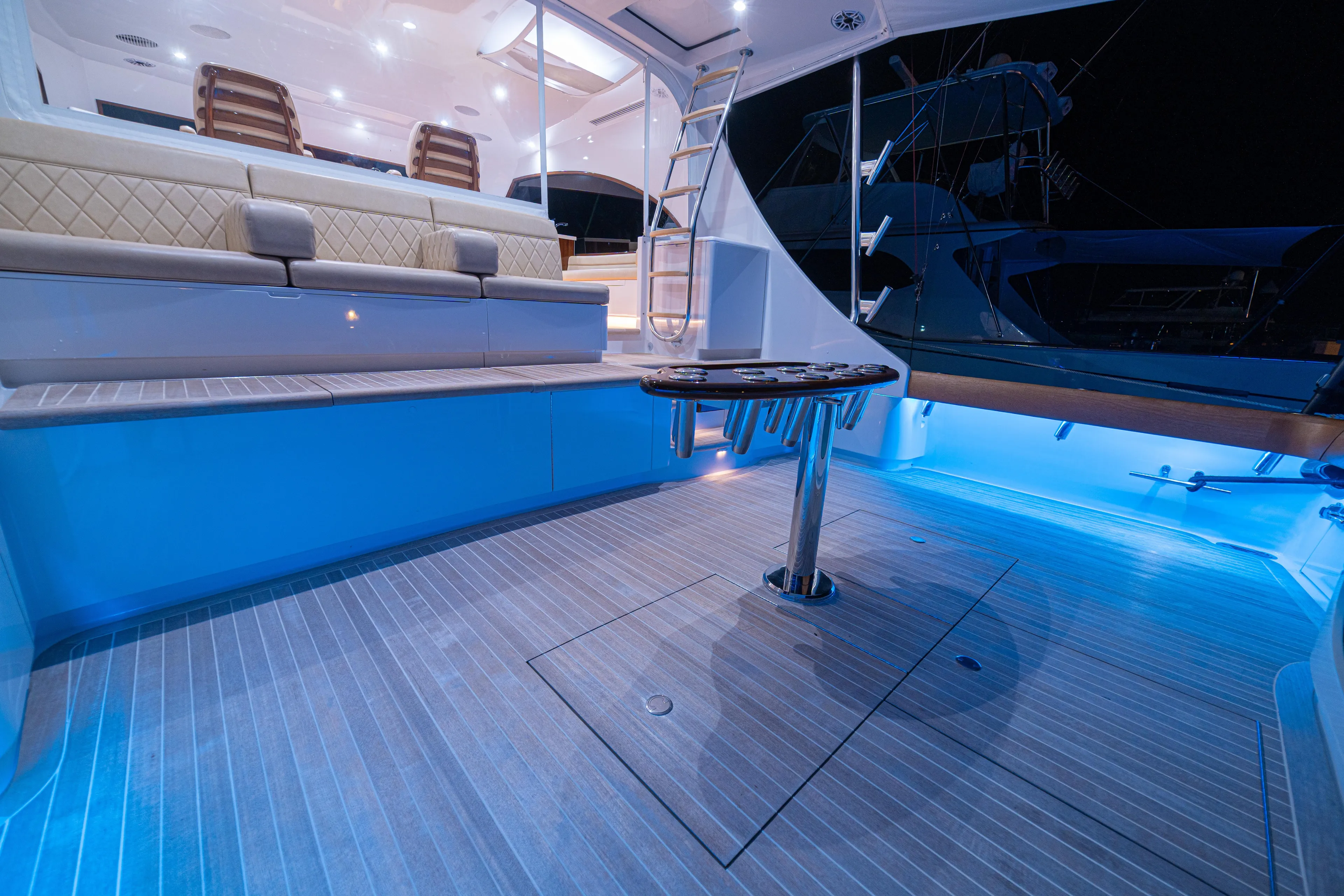  Yacht Photos Pics 2022 Jarrett Bay Flybridge Express yacht with illuminated deck and seating area at night.