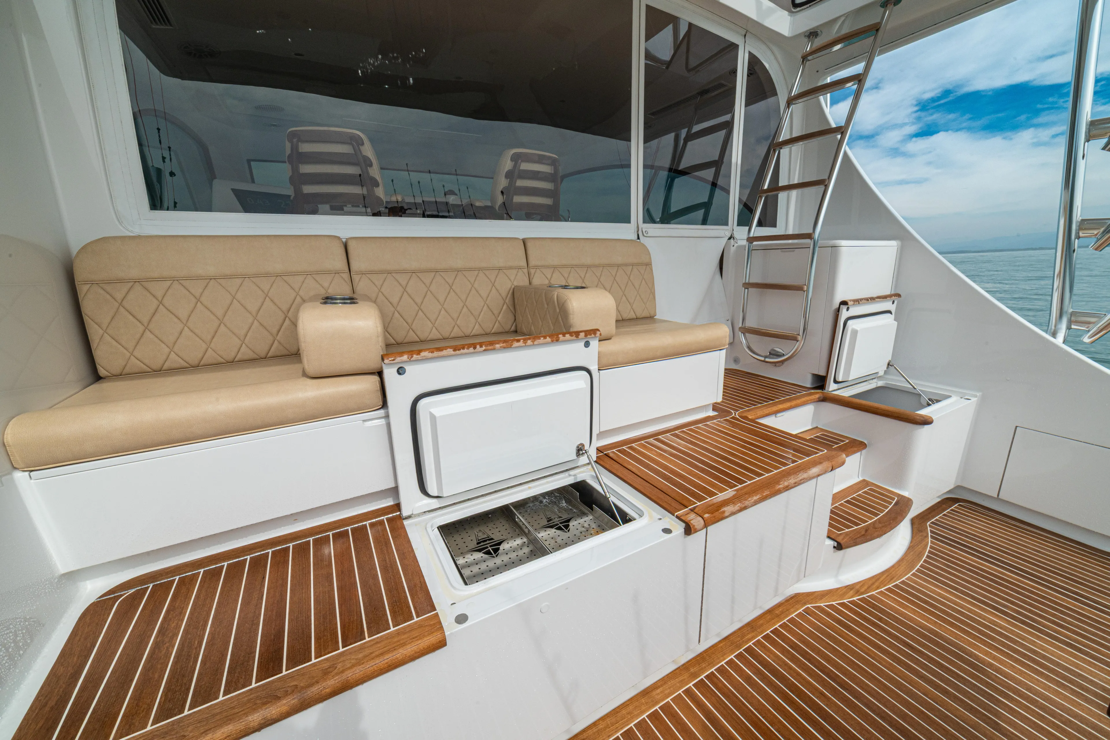  Yacht Photos Pics 2022 Jarrett Bay Flybridge Express yacht with teak deck, beige seating, and ladder.